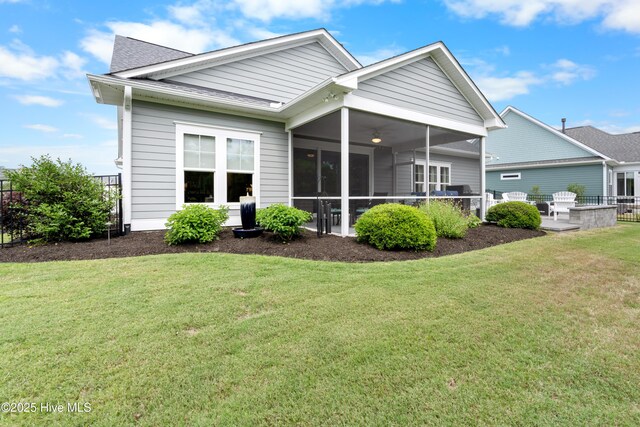 3032 Beachcomber Dr, Southport, NC 28461 - back of house featuring a sunroom, a patio, ceiling fan, and a shingled roof