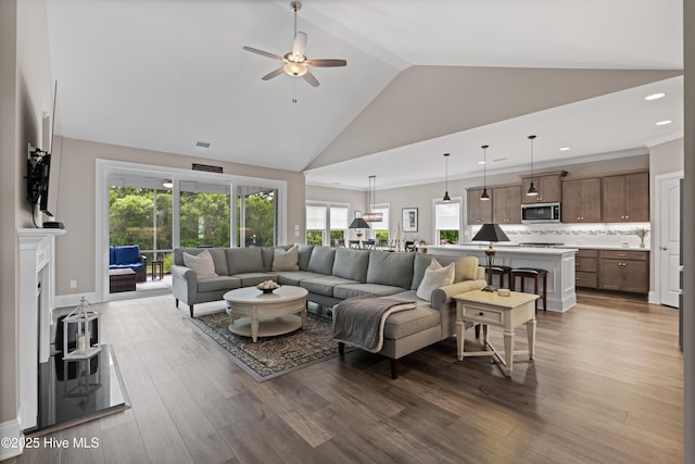 3032 Beachcomber Dr, Southport, NC 28461 - living room featuring ceiling fan, high vaulted ceiling, recessed lighting, wood finished floors, and a fireplace with raised hearth