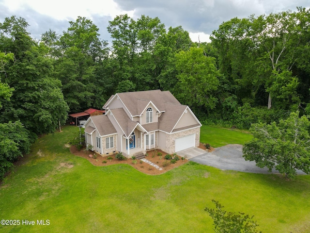 traditional home featuring a garage, driveway, and a front yard