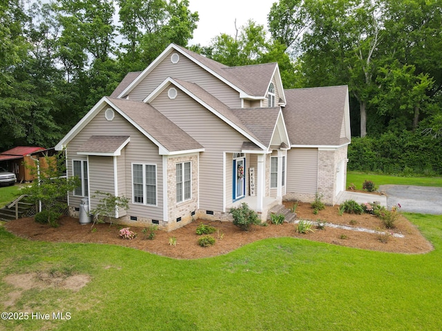view of front of home featuring crawl space, a shingled roof, a front yard, and a garage