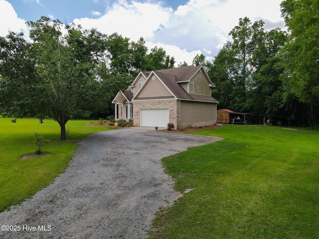 view of side of property featuring driveway, a garage, a lawn, and brick siding