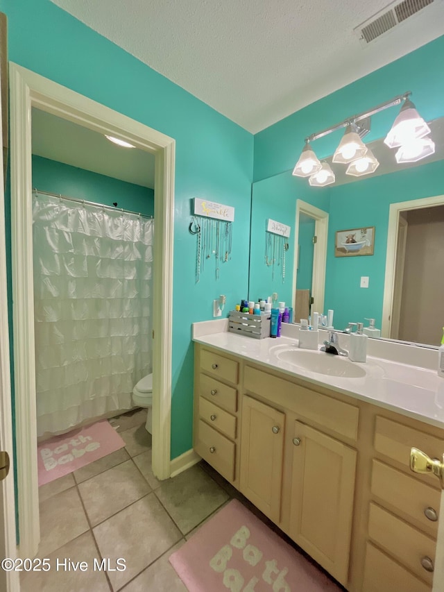 full bath with tile patterned flooring, vanity, toilet, a textured ceiling, and a chandelier