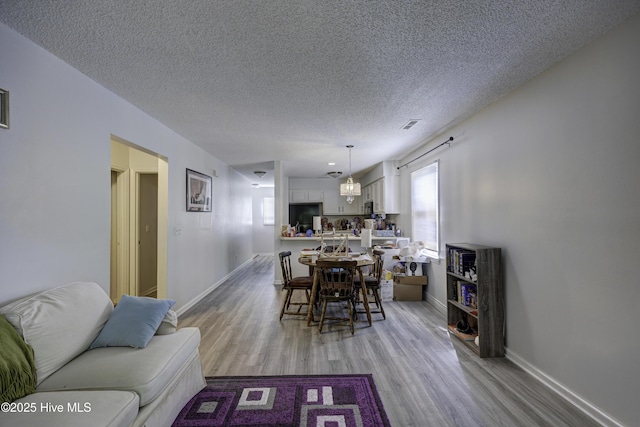 2726 S 17th St Unit C, Wilmington, NC 28412 - dining area featuring healthy amount of natural light, light wood-style flooring, a textured ceiling, and baseboards