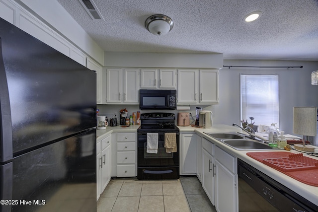 2726 S 17th St Unit C, Wilmington, NC 28412 - kitchen with black appliances, a sink, light countertops, white cabinets, and a textured ceiling