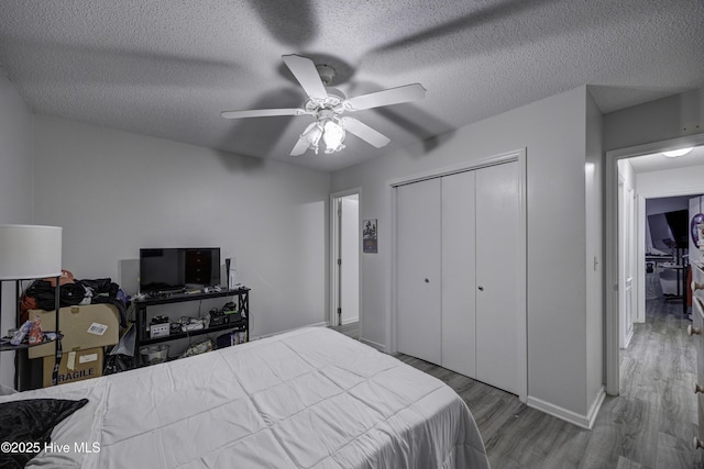 2726 S 17th St Unit C, Wilmington, NC 28412 - bedroom featuring wood finished floors, a closet, baseboards, a textured ceiling, and a ceiling fan