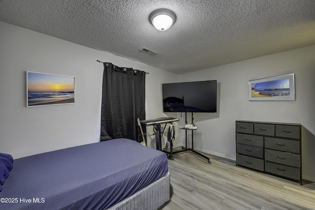 2726 S 17th St Unit C, Wilmington, NC 28412 - bedroom featuring wood finished floors, a textured ceiling, and baseboards