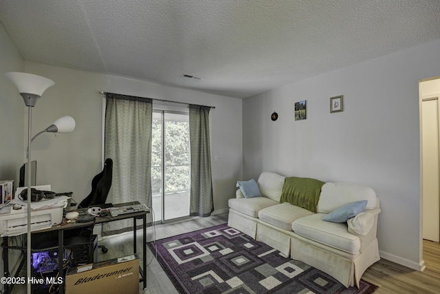 2726 S 17th St Unit C, Wilmington, NC 28412 - living area with wood finished floors, a textured ceiling, baseboards, and an office area