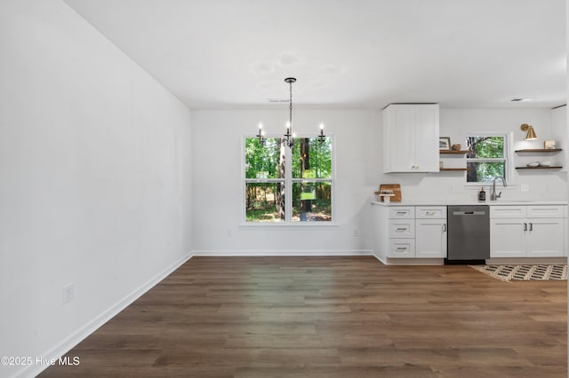 kitchen with stainless steel dishwasher, open shelves, white cabinetry, and a chandelier