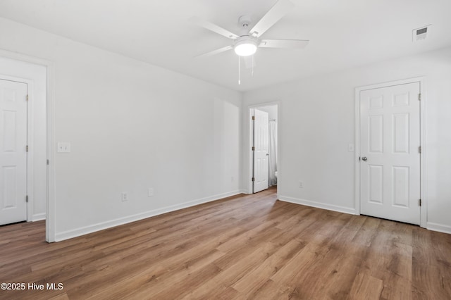 unfurnished bedroom featuring light wood-type flooring, baseboards, and a ceiling fan