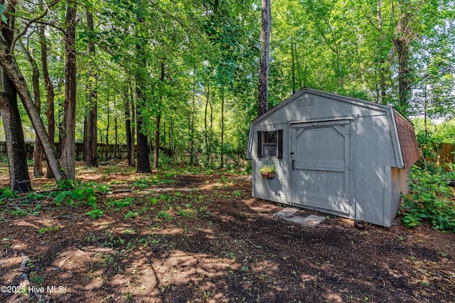 view of shed with a view of trees