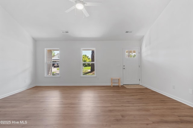 foyer featuring light wood-type flooring, baseboards, and ceiling fan