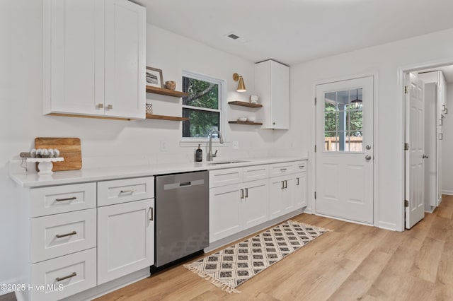 kitchen featuring dishwasher, a sink, open shelves, and healthy amount of natural light