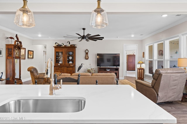 113 Eagle Claw Dr, Calabash, NC 28467 - kitchen featuring a sink, open floor plan, recessed lighting, wood finished floors, and decorative light fixtures