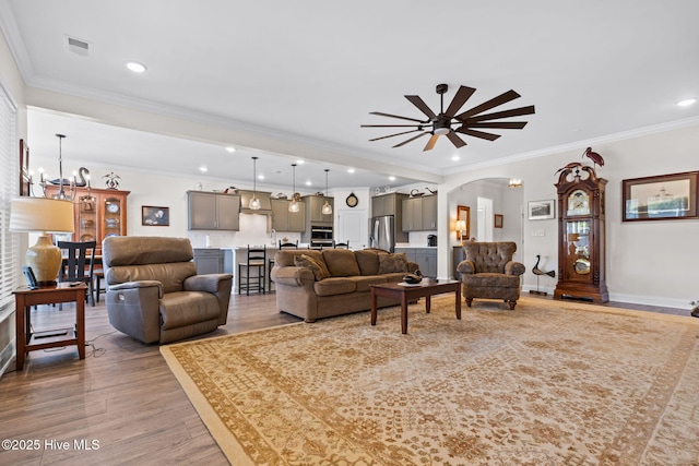 113 Eagle Claw Dr, Calabash, NC 28467 - living area featuring arched walkways, light wood-type flooring, ornamental molding, baseboards, and recessed lighting