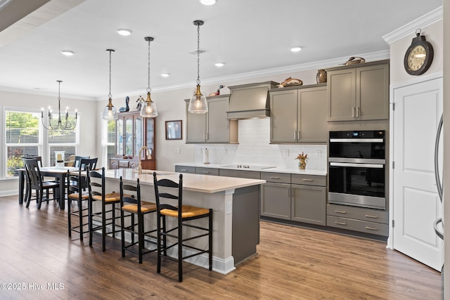 113 Eagle Claw Dr, Calabash, NC 28467 - kitchen with premium range hood, gray cabinetry, a chandelier, dark wood-style flooring, and crown molding