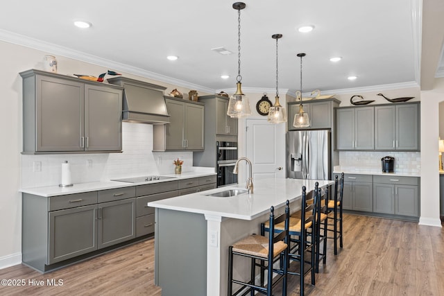 113 Eagle Claw Dr, Calabash, NC 28467 - kitchen with a sink, stainless steel refrigerator with ice dispenser, double oven, black electric cooktop, and a breakfast bar area