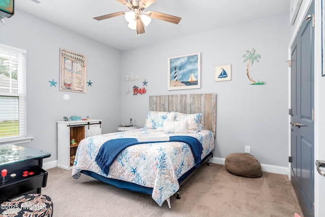 carpeted bedroom with baseboards and a ceiling fan