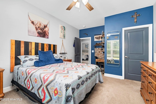bedroom featuring light carpet, baseboards, and ceiling fan