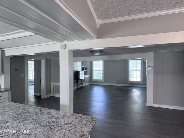 entryway with crown molding, dark wood-style floors, a textured ceiling, and baseboards