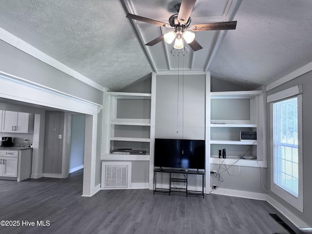 unfurnished living room with a textured ceiling, lofted ceiling, dark wood-style flooring, a ceiling fan, and baseboards