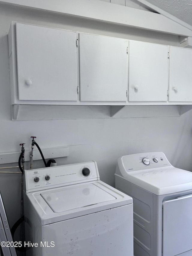 laundry room with cabinet space and washer and dryer