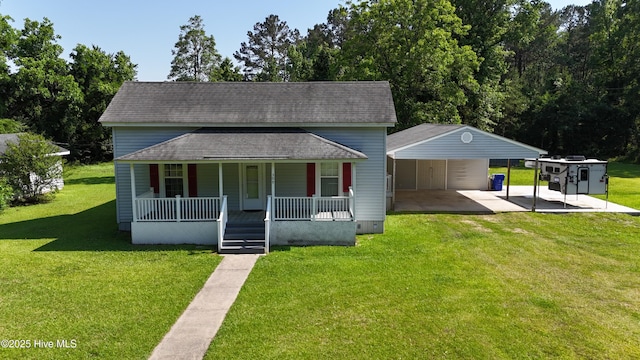 view of front facade featuring covered porch, driveway, a front lawn, and a shingled roof