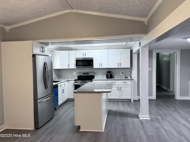 kitchen featuring stainless steel appliances, a kitchen island, white cabinetry, dark wood-type flooring, and a textured ceiling
