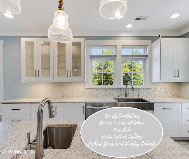 201 W Yacht Dr, Oak Island, NC 28465 - kitchen featuring a sink, backsplash, white cabinets, and recessed lighting