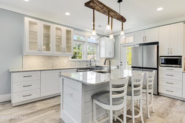 201 W Yacht Dr, Oak Island, NC 28465 - kitchen with appliances with stainless steel finishes, plenty of natural light, a sink, recessed lighting, and white cabinetry