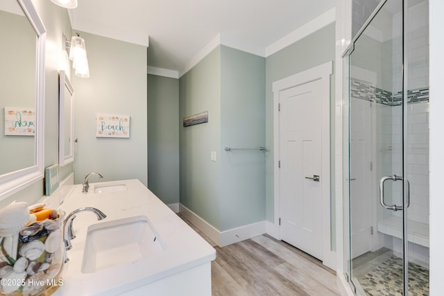 201 W Yacht Dr, Oak Island, NC 28465 - bathroom featuring a stall shower, double vanity, and wood finished floors