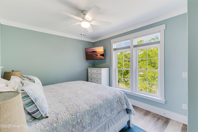 201 W Yacht Dr, Oak Island, NC 28465 - bedroom with wood finished floors, baseboards, and a ceiling fan