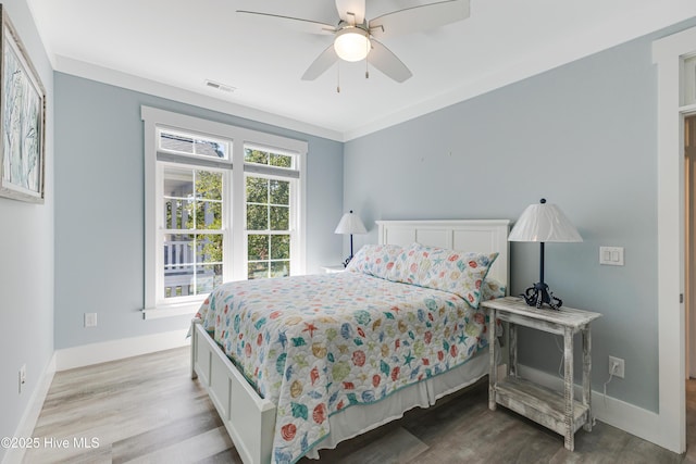 201 W Yacht Dr, Oak Island, NC 28465 - bedroom featuring baseboards, wood finished floors, and ceiling fan