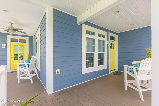 201 W Yacht Dr, Oak Island, NC 28465 - wooden deck featuring a porch and ceiling fan