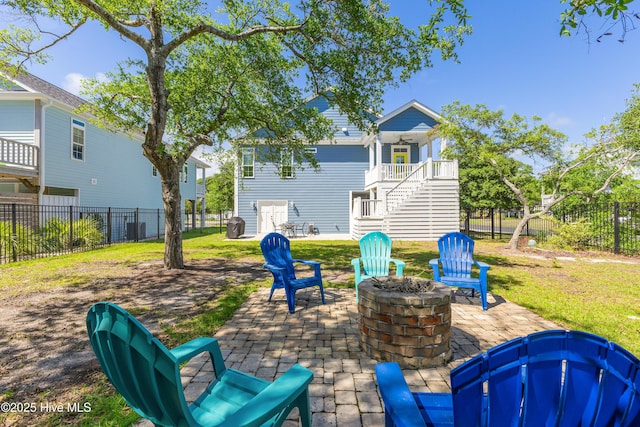 201 W Yacht Dr, Oak Island, NC 28465 - view of patio / terrace with an outdoor fire pit, stairway, and a fenced backyard