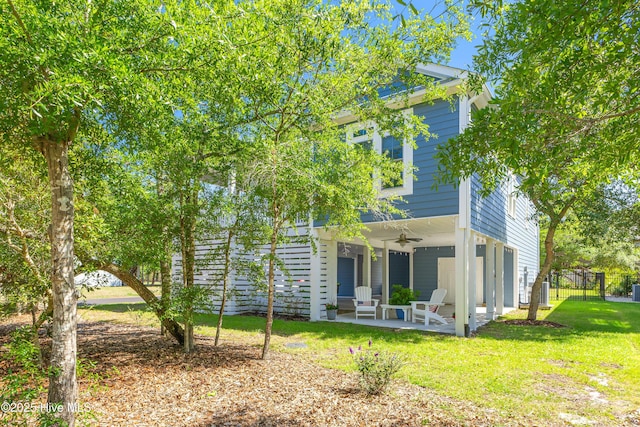 201 W Yacht Dr, Oak Island, NC 28465 - back of property with a ceiling fan and a patio area