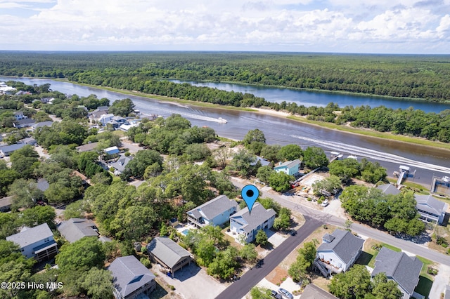 201 W Yacht Dr, Oak Island, NC 28465 - aerial perspective of suburban area with a heavily wooded area and a nearby body of water