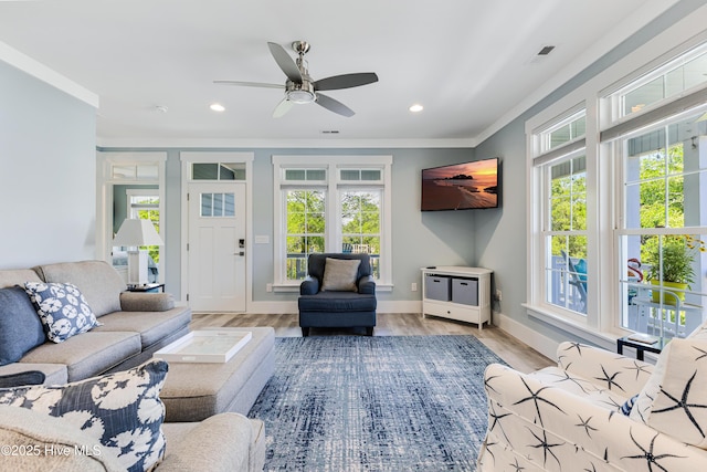 201 W Yacht Dr, Oak Island, NC 28465 - living area with ornamental molding, a ceiling fan, recessed lighting, baseboards, and light wood-style floors