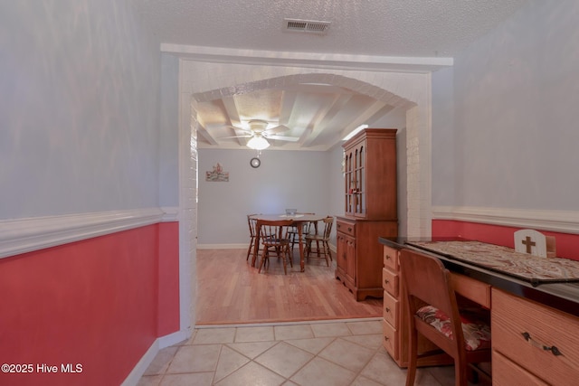 178 Stanley St, West End, NC 27376 - dining room with a ceiling fan, arched walkways, a textured ceiling, and light tile patterned floors