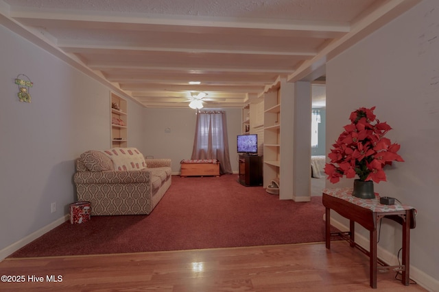 178 Stanley St, West End, NC 27376 - carpeted living room featuring beam ceiling, baseboards, wood finished floors, and built in features