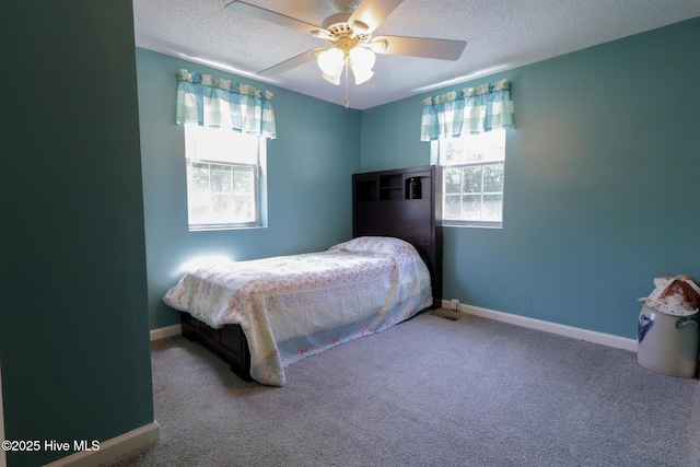 178 Stanley St, West End, NC 27376 - bedroom with a textured ceiling, baseboards, carpet, and a ceiling fan