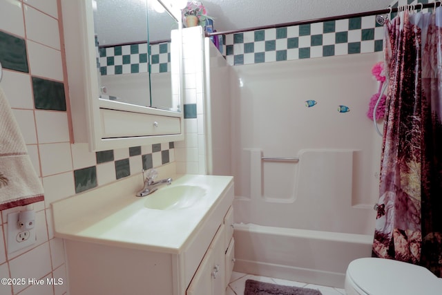 178 Stanley St, West End, NC 27376 - bathroom with tile walls, shower / bath combo with shower curtain, toilet, vanity, and tasteful backsplash