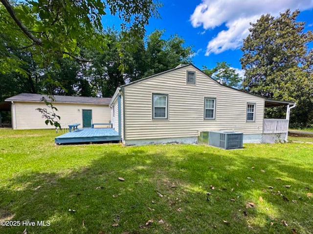 178 Stanley St, West End, NC 27376 - back of house featuring cooling unit, a deck, and a lawn