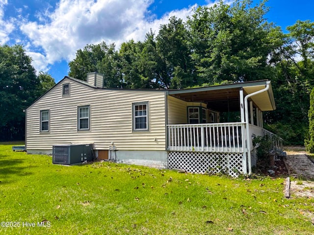 178 Stanley St, West End, NC 27376 - rear view of house with cooling unit, a yard, a chimney, and a porch