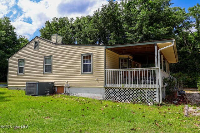 178 Stanley St, West End, NC 27376 - view of property exterior with central AC unit, a lawn, and a chimney