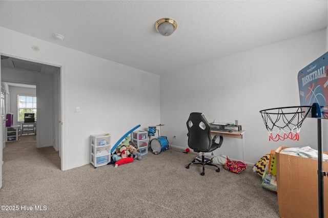 recreation room featuring carpet and a textured ceiling