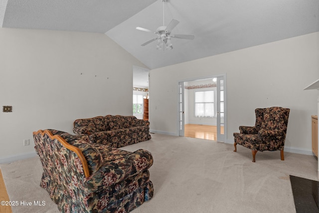 sitting room featuring carpet, lofted ceiling, ceiling fan, and baseboards