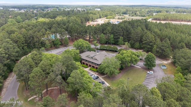 aerial view of property and surrounding area featuring a forest