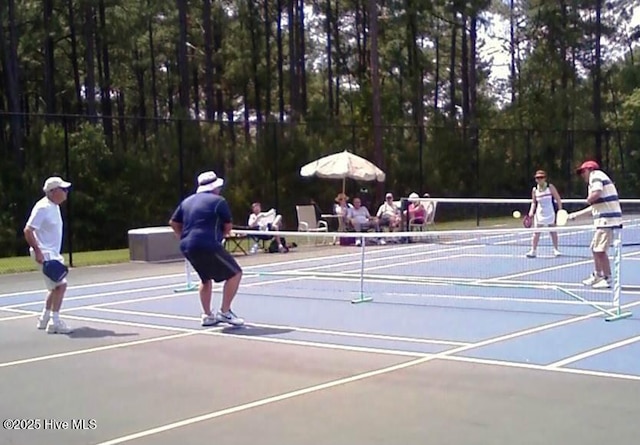 view of tennis court featuring fence and community basketball court