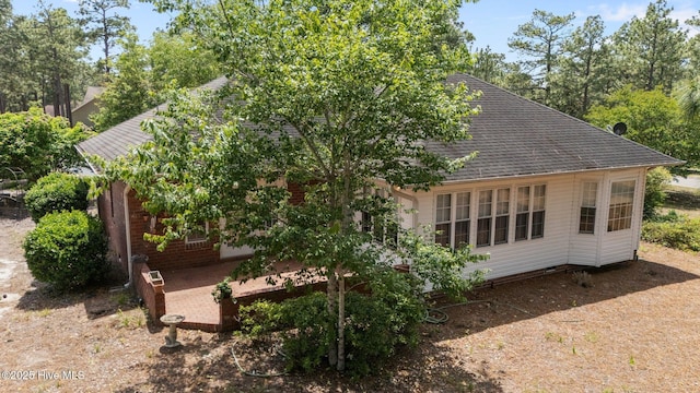 view of property exterior with a shingled roof and crawl space