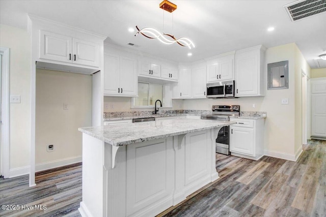 406 Mercer St, Goldsboro, NC 27530 - kitchen with stainless steel appliances, baseboards, white cabinets, light wood-type flooring, and recessed lighting